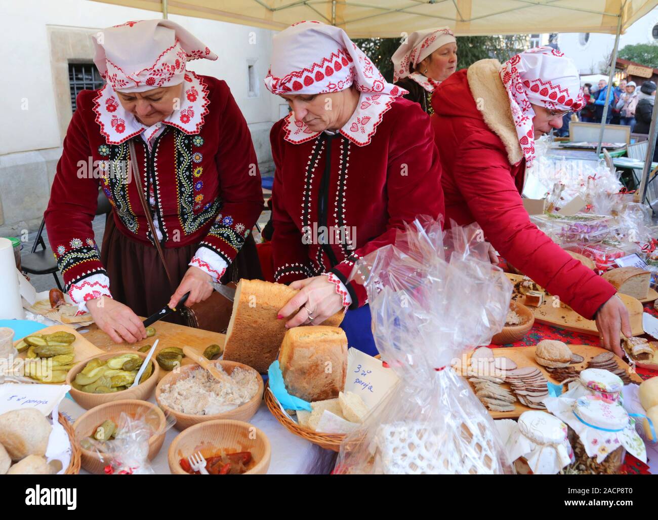 Cracovie. Cracovie. Pologne.rue annuelle de Noël juste à la place du marché principal. Les femmes dans les costumes traditionnels au stand de nourriture. Banque D'Images