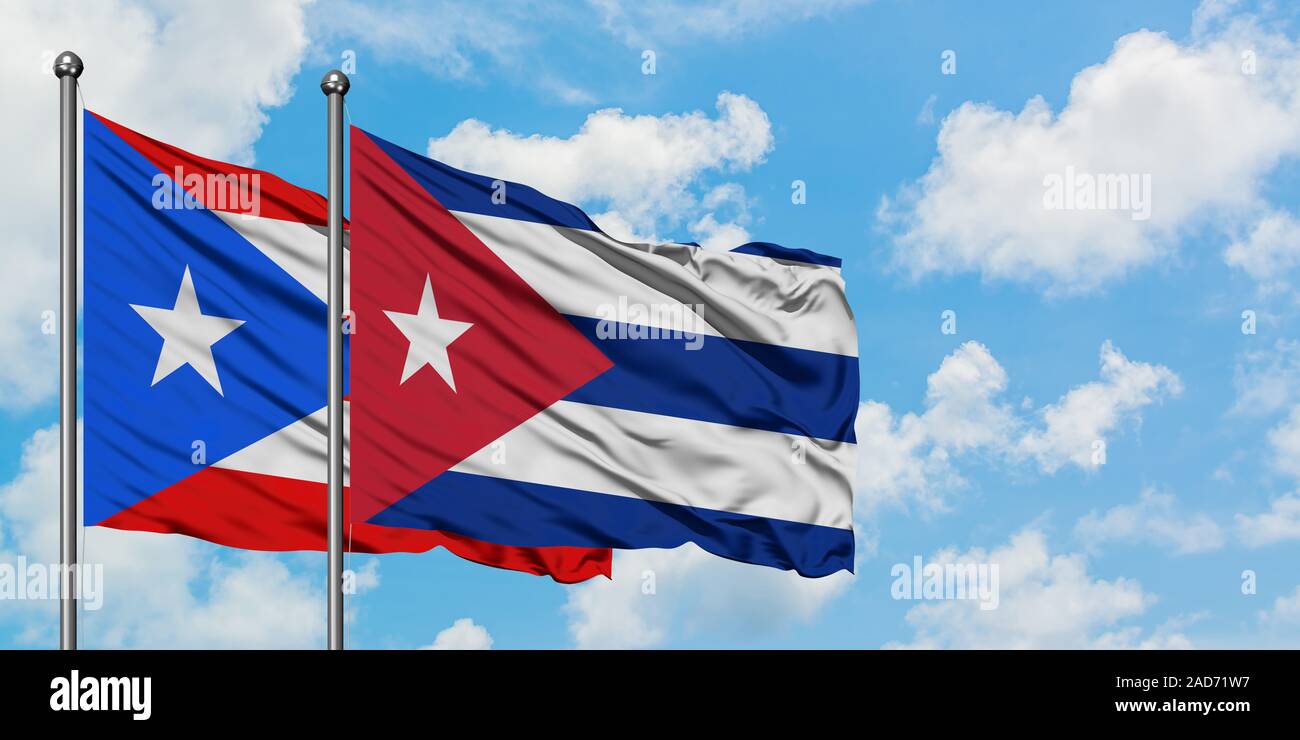 Puerto Rico et Cuba drapeaux dans le vent contre ciel bleu nuageux blanc  ensemble. Concept de diplomatie, de relations internationales Photo Stock -  Alamy