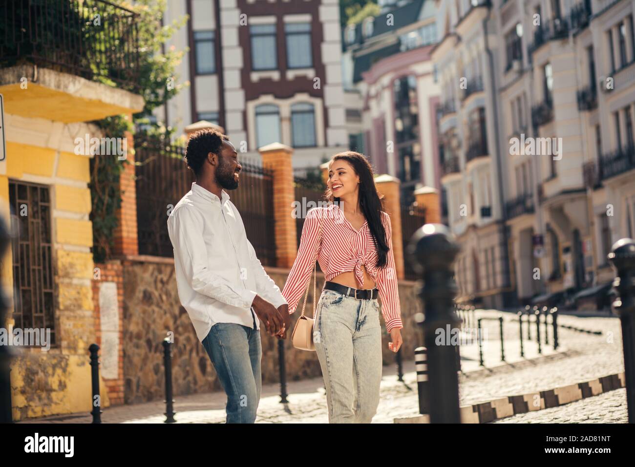 Joyful couple holding hands and strolling Banque D'Images