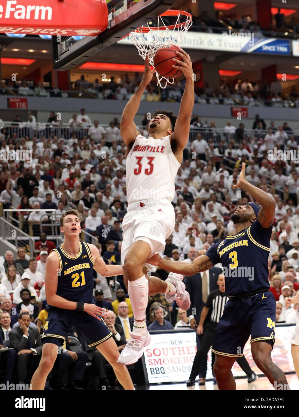 Louisville, États-Unis. 06Th Dec, 2019. Louisville Cardinals Jordanie Nwora (33) se bat pour obtenir son tir sous la pression de la Michigan Wolverines Zavier Simpson (3) au cours de la première moitié du jeu sur KFY Yum ! Dans le centre de Louisville, Kentucky, le 3 décembre 2019. Photo de John Sommers II /Crédit : UPI UPI/Alamy Live News Banque D'Images