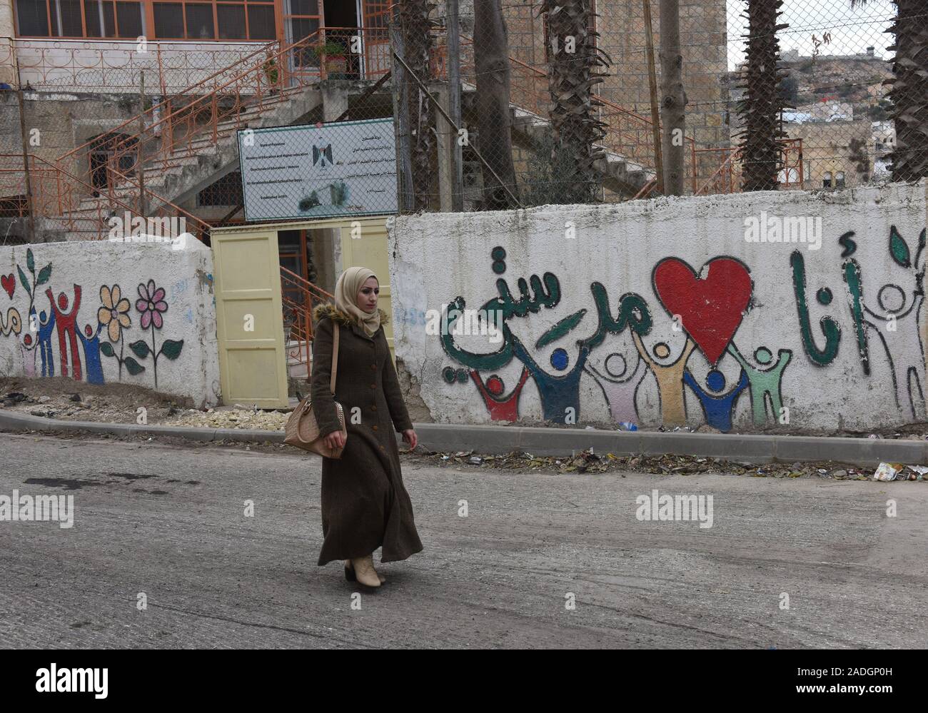 Une femme palestinienne graffiti marche dernières près du Tombeau des Patriarches, ou de la mosquée, dans la ville divisée de Hébron, en Cisjordanie, le Mercredi, Décembre 4, 2019. Le Ministre israélien de la Défense, Naftali Bennett a ordonné aux fonctionnaires de commencer à planifier une nouvelle colonie juive au coeur d'Hébron, dont les responsables palestiniens dire, c'est la suite de Le président américain Donald Trump a décidé de légitimer les colonies. Photo par Debbie Hill/UPI Banque D'Images