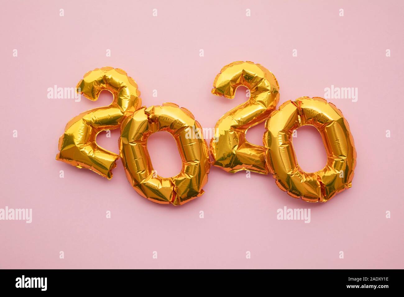 Nouvelle Année 2020 célébration. Parti feuille d'or sur fond rose pastel ballons Banque D'Images