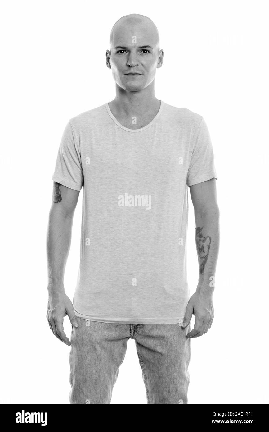 Studio shot of young handsome bald man standing Banque D'Images Studio shot of young handsome bald man standing Banque D'Images