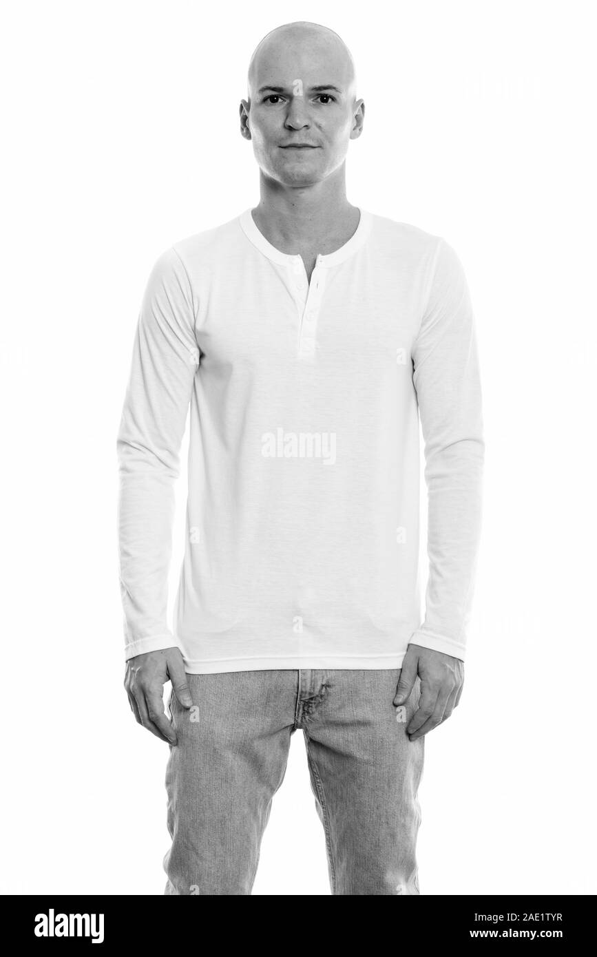 Studio shot of young handsome bald man standing Banque D'Images Studio shot of young handsome bald man standing Banque D'Images