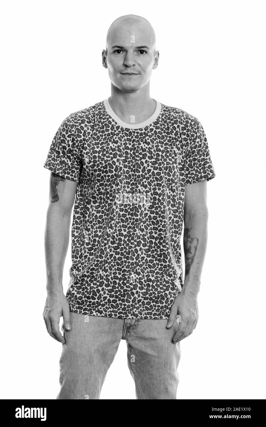 Studio shot of young handsome bald man standing Banque D'Images Studio shot of young handsome bald man standing Banque D'Images