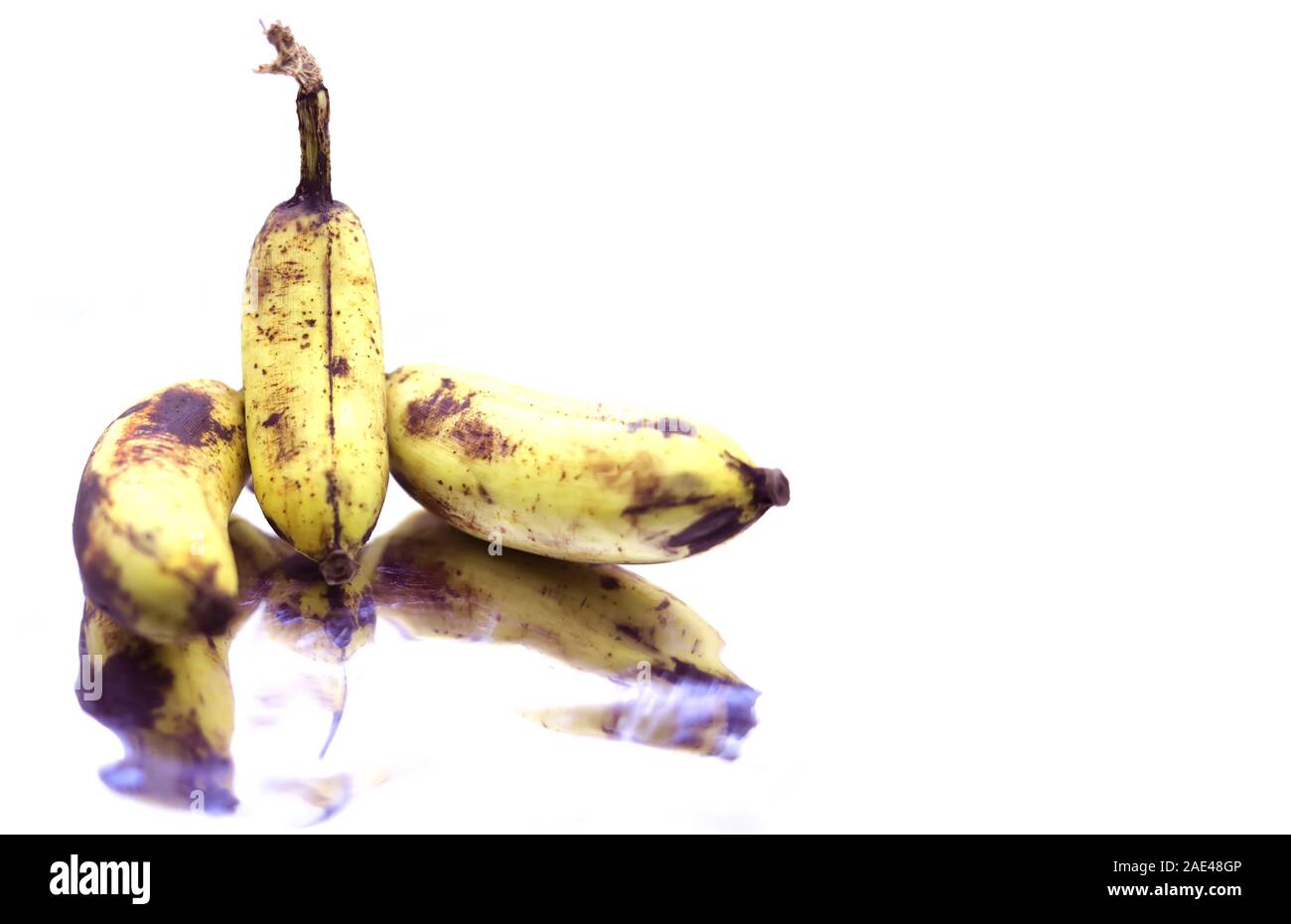 Les bananes jaunes mûrs fruits, bande de bananes mûres avec des taches sombres sur un fond blanc Banque D'Images