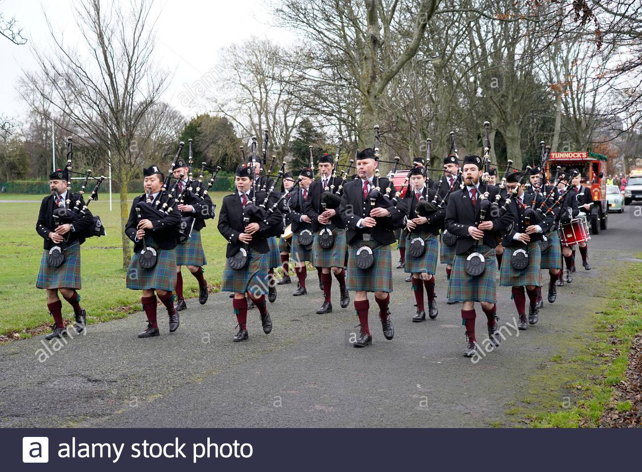 Edinburgh, Ecosse, Royaume-Uni. 7 décembre 2019. Festival Noël à Stockbridge Édimbourg, le festival démarre avec la Santa parade menée par le Stockbridge Pipe Band, suivi par le père Noël et ses rennes, l'itinéraire se termine à Inverleith Park. Stockbridge pipe band sur les sentiers de l'Inverleith Park. Credit : Craig Brown/Alamy Live News Banque D'Images