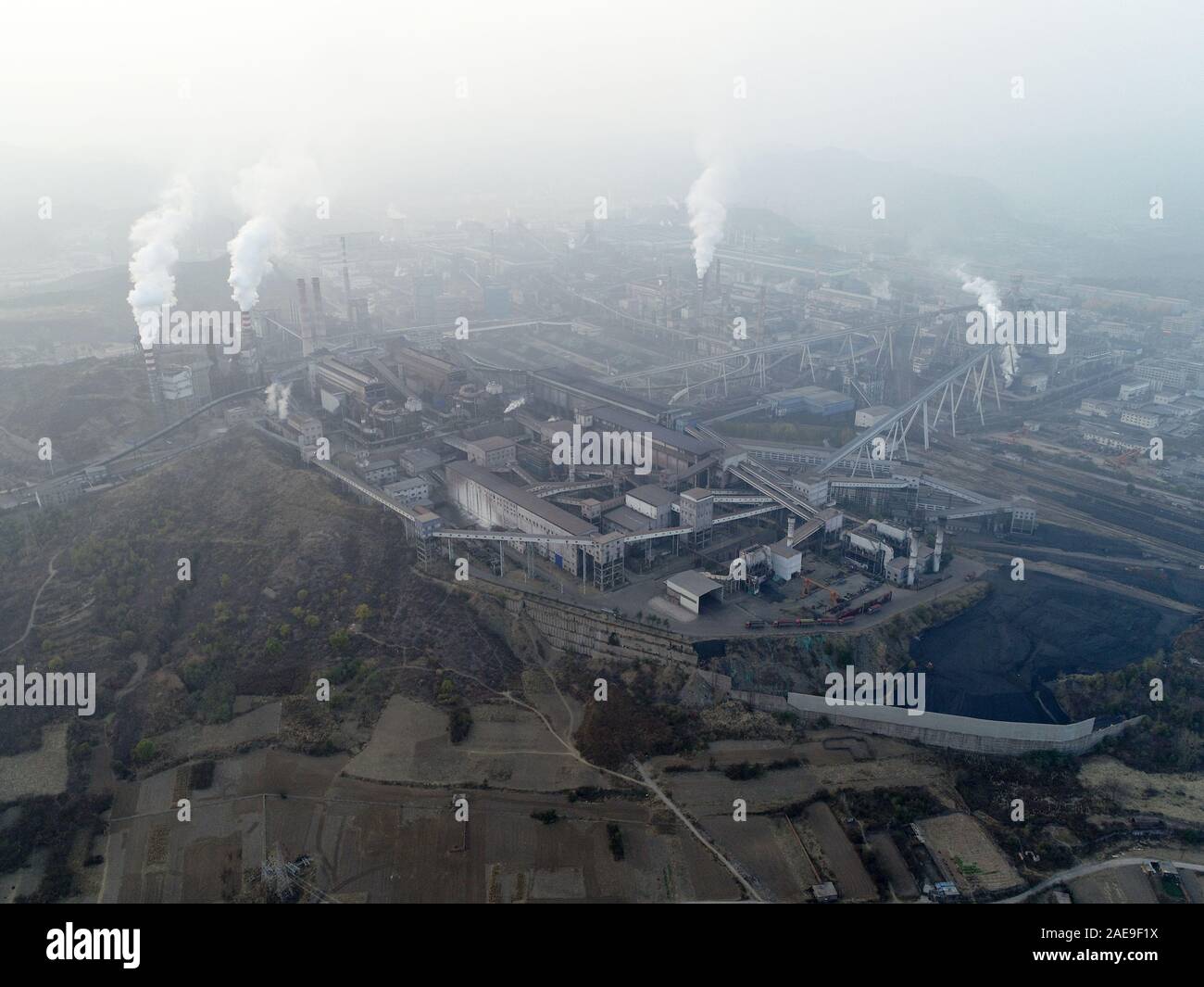 Vue aérienne de la grande usine en Chine. La pollution de l'air par la fumée sortir des cheminées. Les Centrales électriques à combustibles fossiles charbon cheminées émettent du dioxyde de carbone la pollution. Chengde, Chine. Décembre 12th, 2019 Banque D'Images