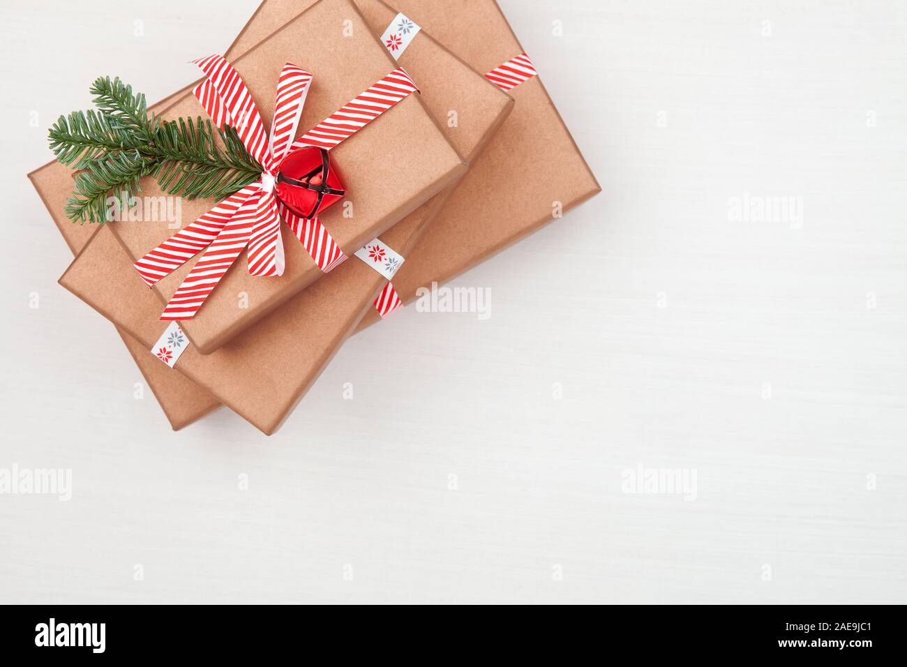 Cadeaux de Noël sapin décoré les branches d'arbres et des cloches sur fond blanc Banque D'Images