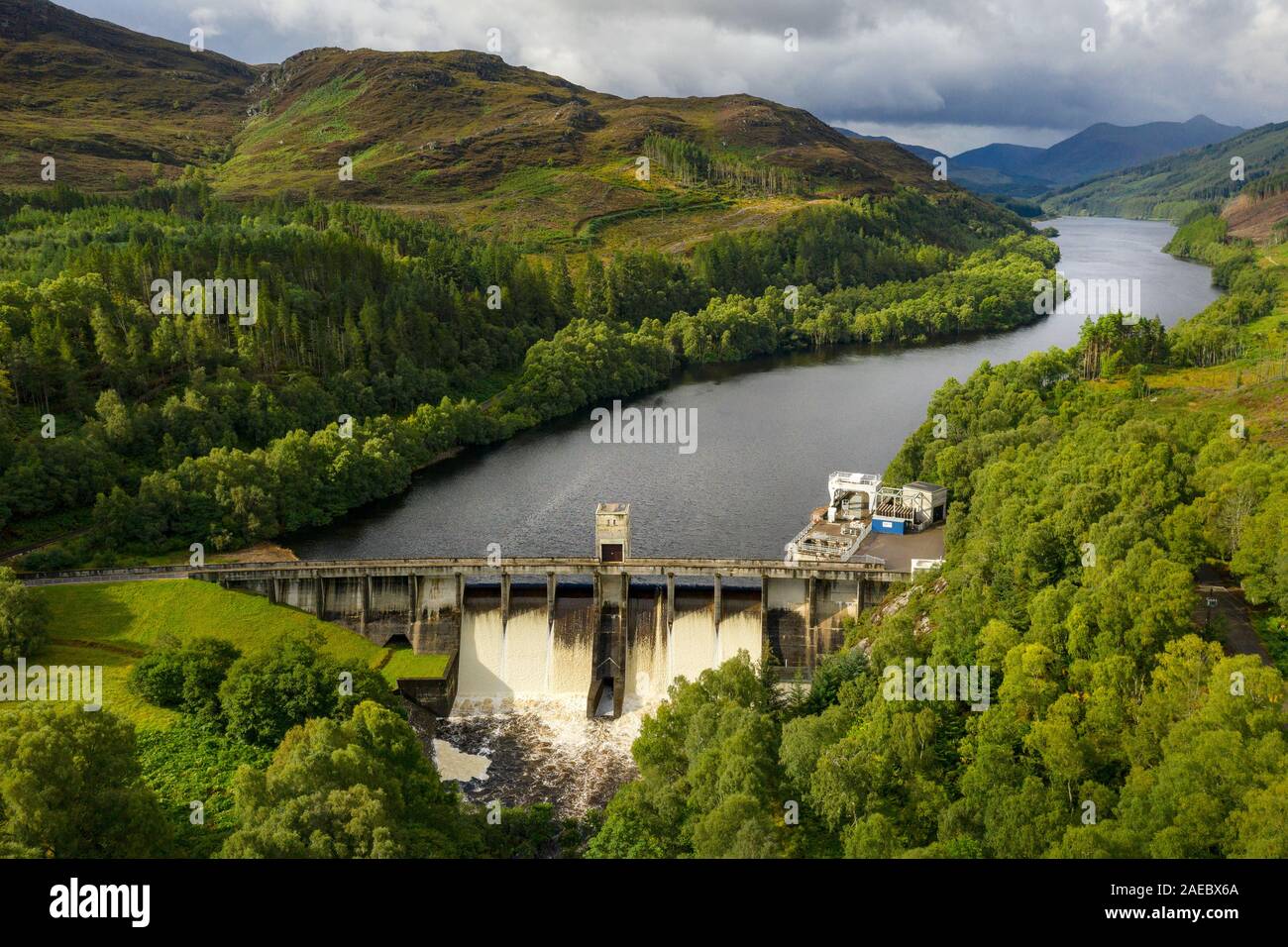 The Corporate Finance l'eau circulant sur le barrage hydroélectrique de l'Ecosse, Highland avec SDI Loch étendant derrière le barrage. Banque D'Images