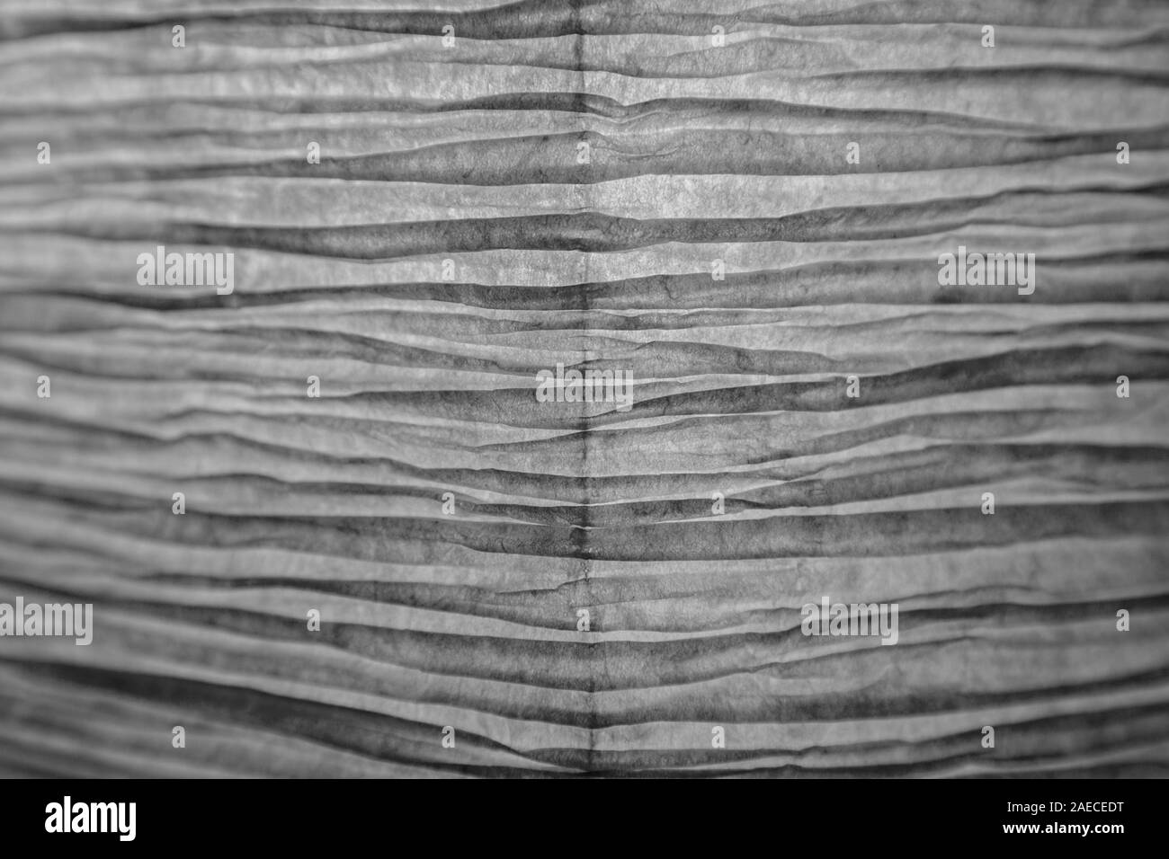 Close-up of a froissé papier jaune rétroéclairé et abat-jour en noir et blanc. Concentré sur le centre, les bords flous. Fond texturé de haute résolution Banque D'Images