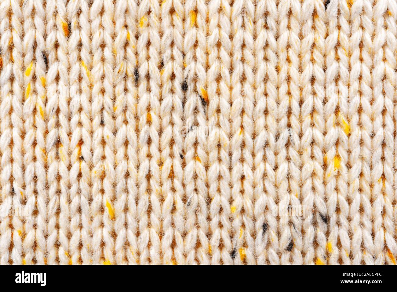 La texture de tissu beige tricot laine entrecoupées de fil jaune. Voir Portrait fond chandail Banque D'Images