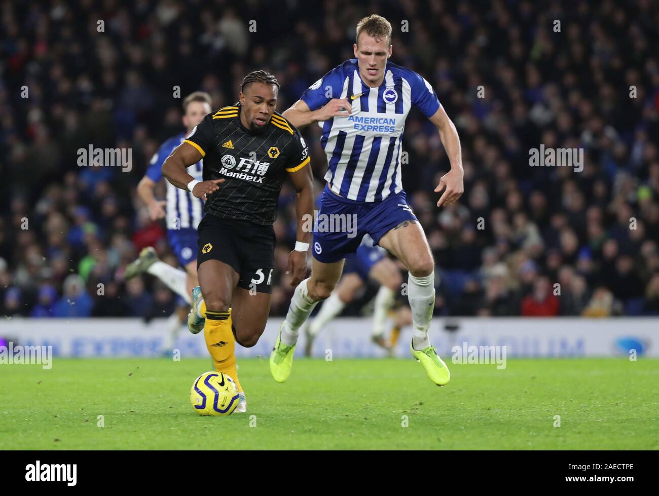 Adama Traore de loups eddv pour la balle contre Brighton's Dan brûler pendant le premier match de championnat entre Brighton & Hove Albion Wolverhampton Wanderers et à l'Amex Stadium à Brighton. 08 Décembre 2019 Banque D'Images