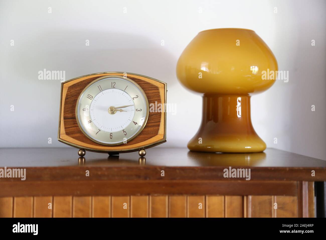 Décoration du milieu du siècle. L'horloge rétro ou rétro se concentre sur un fond de tableau latéral avec une lampe rétro à champignons en verre soufflé Banque D'Images