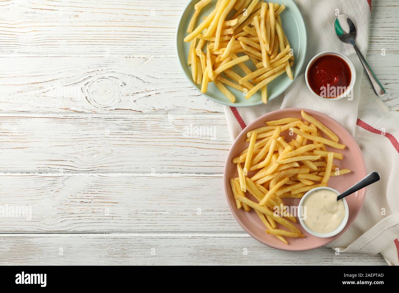 Assiettes de frites, doublures, les sauces, les fourches sur fond noir, de l'espace pour le texte. Vue d'en haut Banque D'Images