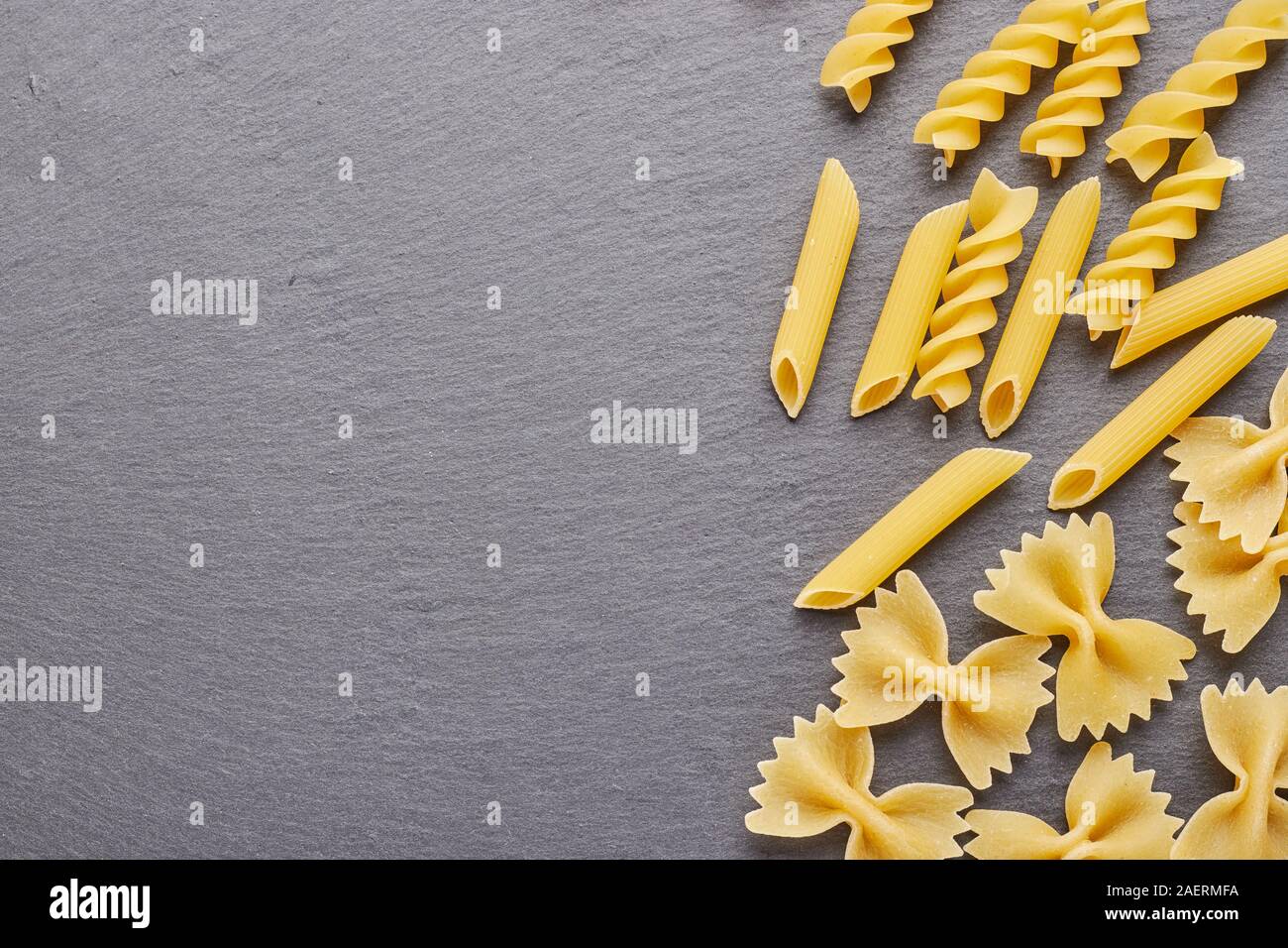 Ingrédients pour la cuisson des pâtes sur le fond d'ardoise noire avec beaucoup d'espace libre pour votre projet. Banque D'Images