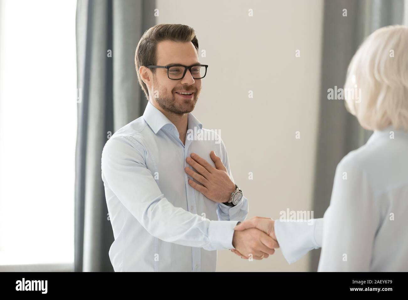 Smiling man handshake femme collègue se familiariser Banque D'Images