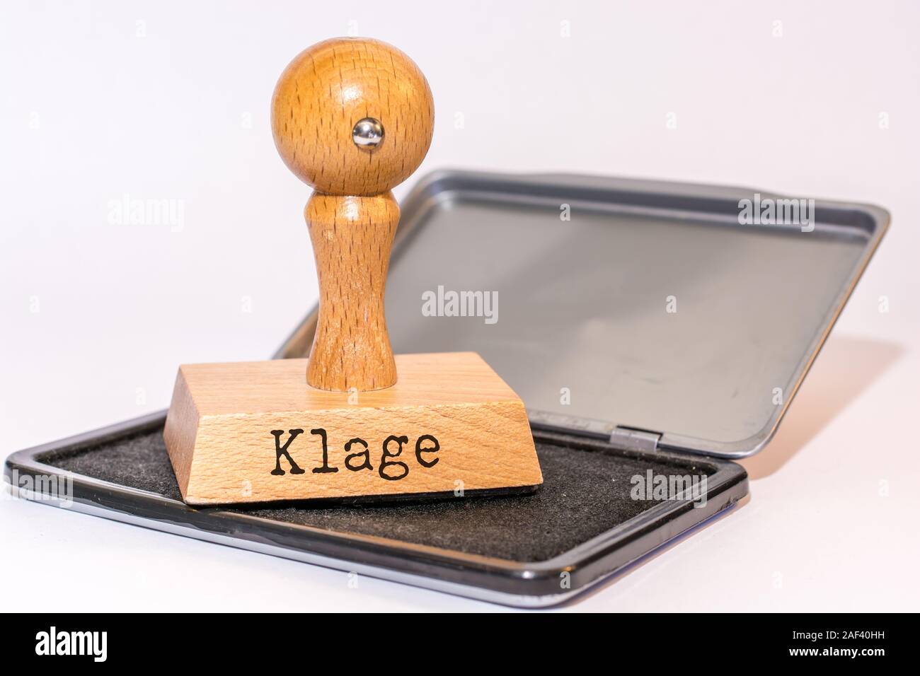 Tampon encreur et stamp au mot allemand 'suit' Banque D'Images