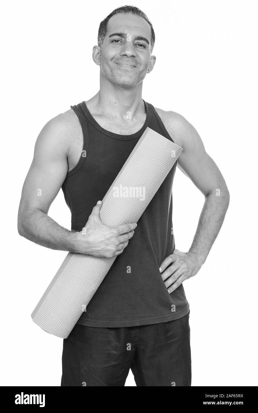 Happy mature man holding Persique tapis de yoga pour se préparer à la salle de sport Banque D'Images