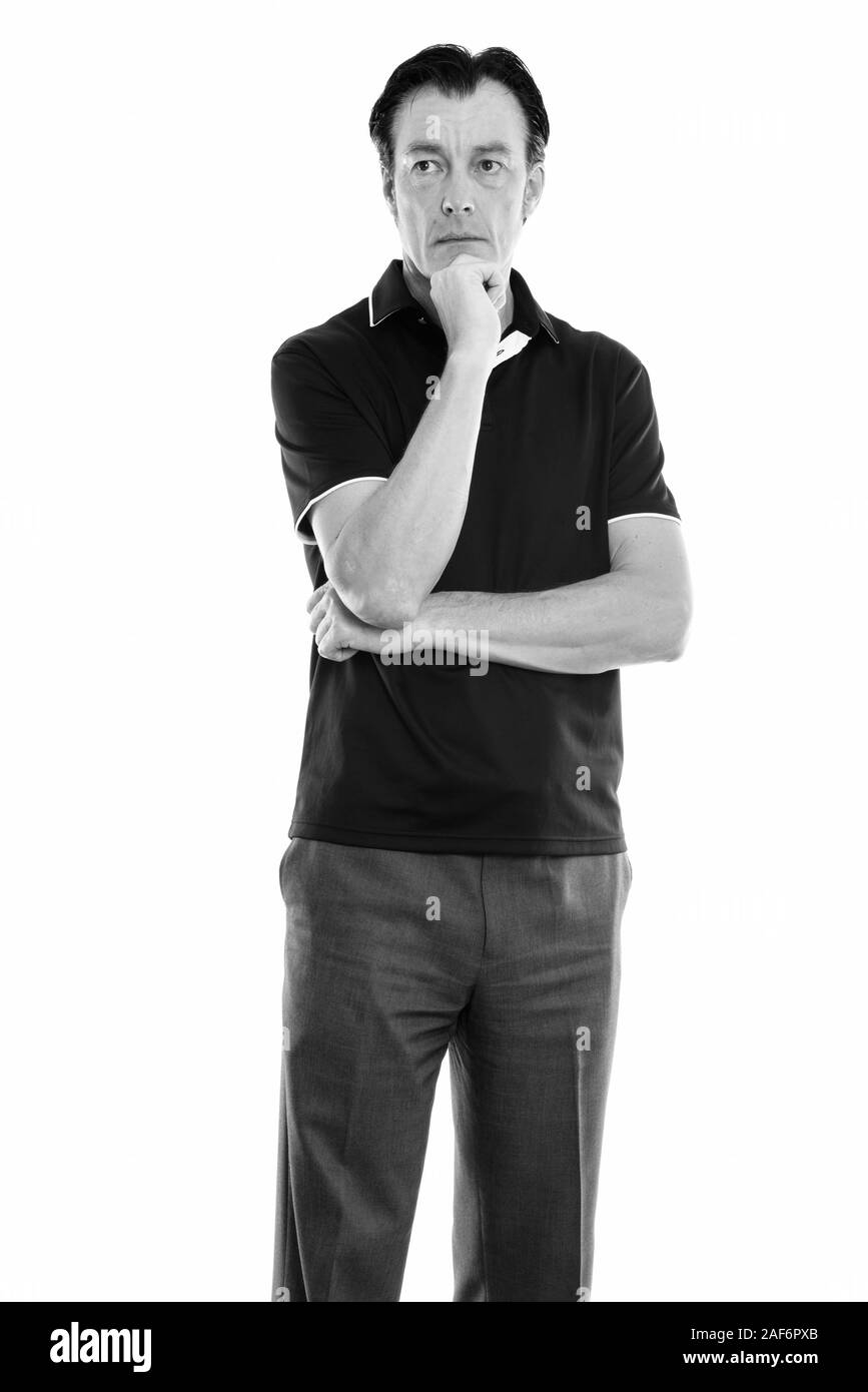 Studio shot of young handsome man standing en pensant Banque D'Images Studio shot of young handsome man standing en pensant Banque D'Images
