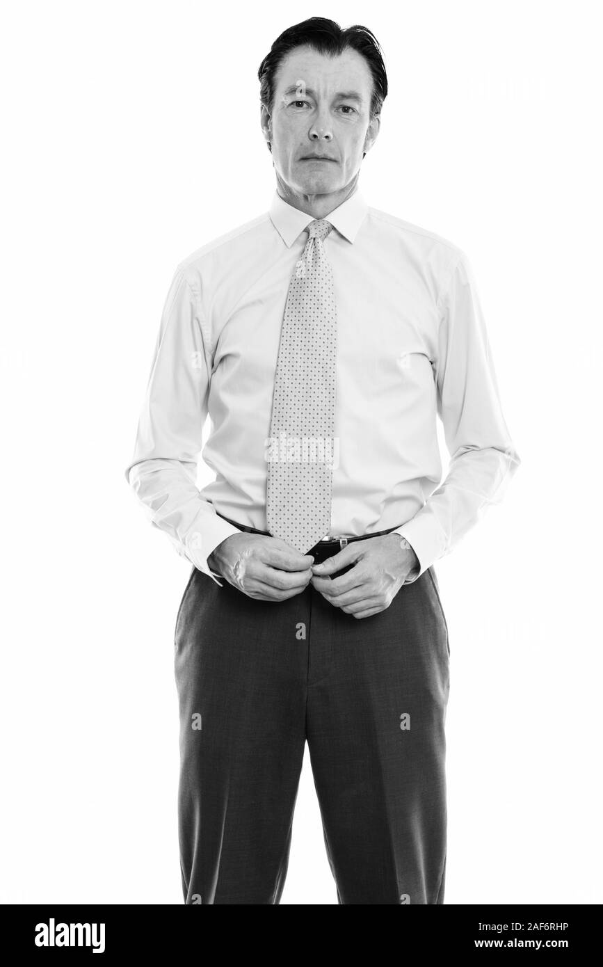 Studio shot of young handsome businessman standing Banque D'Images Studio shot of young handsome businessman standing Banque D'Images