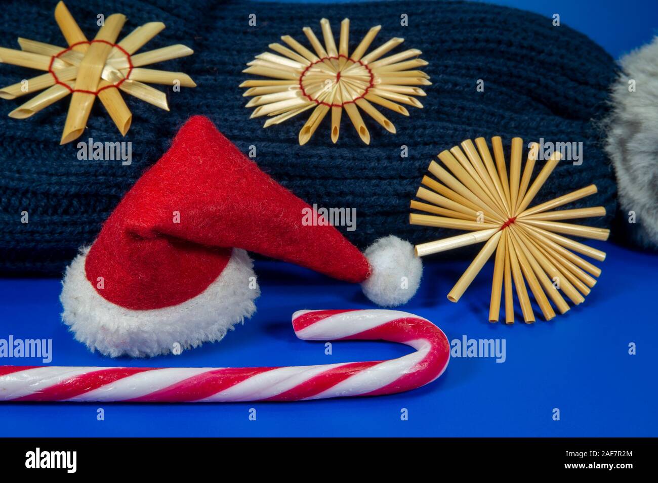 Cool hiver bleu fond de Noël avec bonnet de laine tricoté à la main, flocons de paille de canne, et un rouge Santa hat avec copie sp Banque D'Images