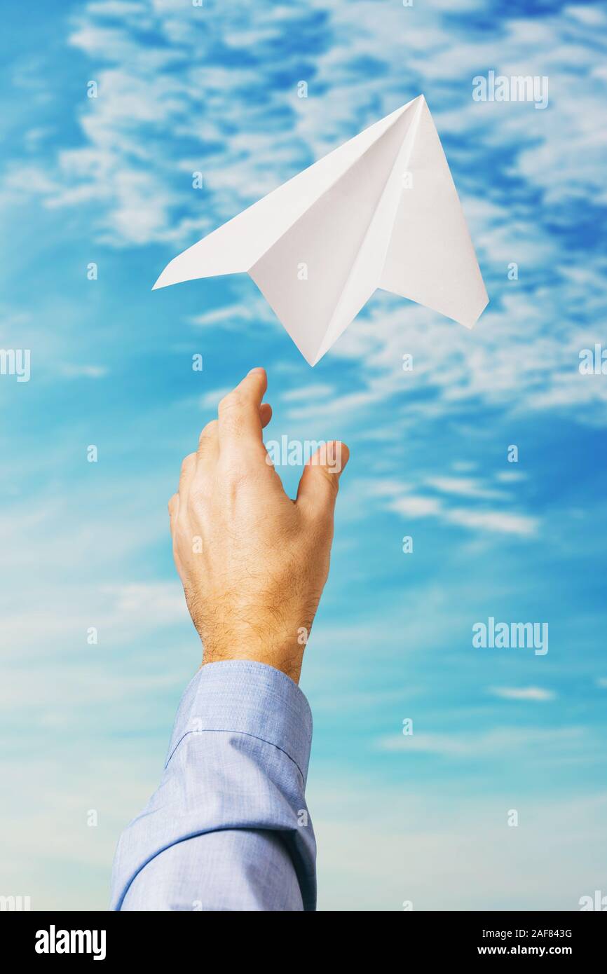 Businessman a lancé un avion en papier dans le ciel, comme un symbole de l'entreprise Banque D'Images