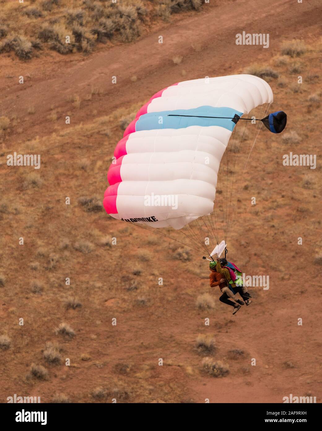 Deux cavaliers de base faisant un 'Mr. Bill' saut en tandem à partir de l'espace Net Mothership 950 pieds au-dessus du plancher de minéral Canyon près de Moab, Utah. Depuis le j Banque D'Images