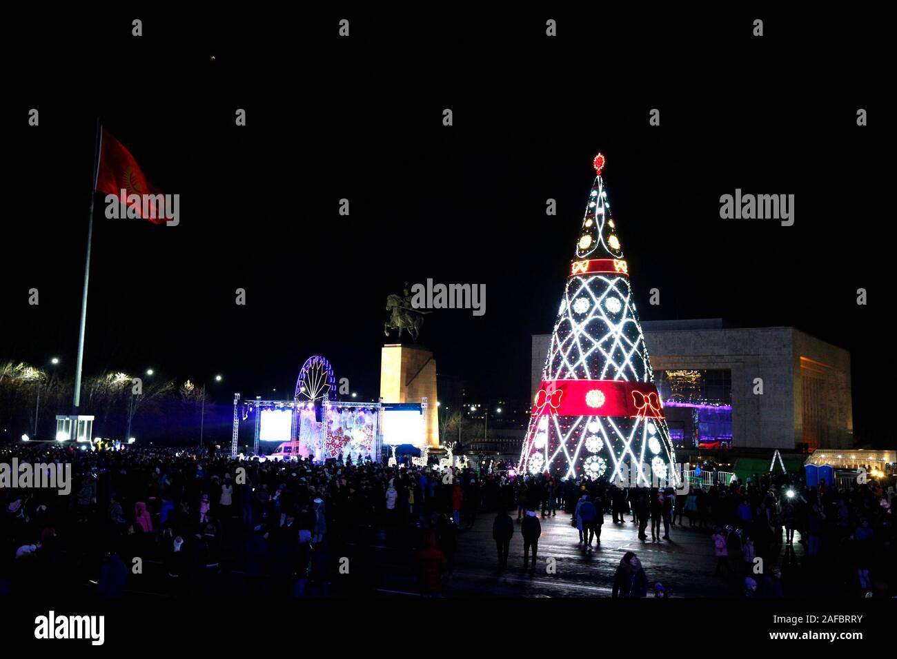 (191214) -- BISHKEK, 14 décembre 2019 (Xinhua) -- photos prises le 13 décembre 2019 montre la scène d'un allègement de l'arbre de Noël cérémonie à la place Ala-Too à Bichkek, capitale du Kirghizistan. Des centaines de résidents locaux ont assisté à la cérémonie d'éclairage du 25 mètres de haut sur l'arbre de Noël Vendredi. (Photo par Roman/Xinhua) Banque D'Images