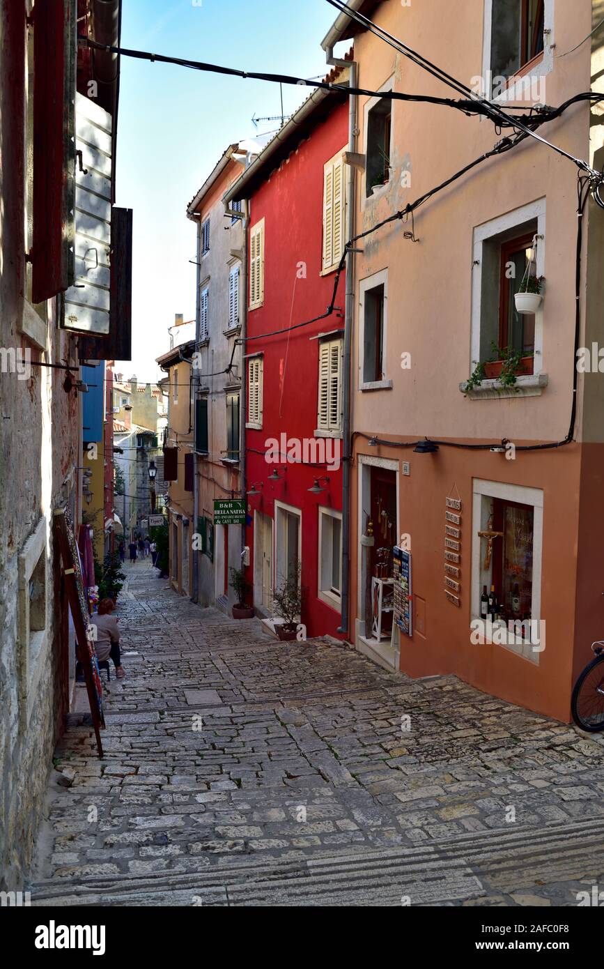 Petite rue piétonne pavée avec des étapes et des bâtiments, Rovinj, Croatie Banque D'Images