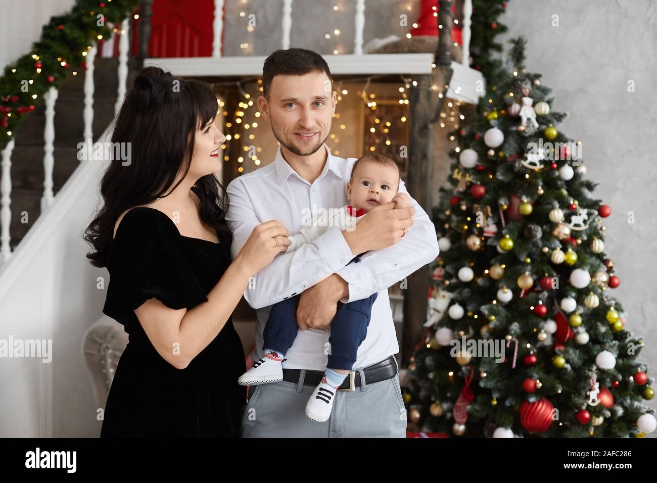 Jeune Couple Avec Un Bebe Debout A Cote D Un Arbre De Noel Decore Famille Heureuse Avec Bebe Celebrant Le Nouvel An A La Maison Jeune Femme En Soiree Photo Stock Alamy Jeune Couple Avec Un Bebe Debout A Cote D Un Arbre De Noel Decore Famille Heureuse Avec Bebe Celebrant Le Nouvel An A La Maison Jeune Femme En Soiree Photo Stock Alamy