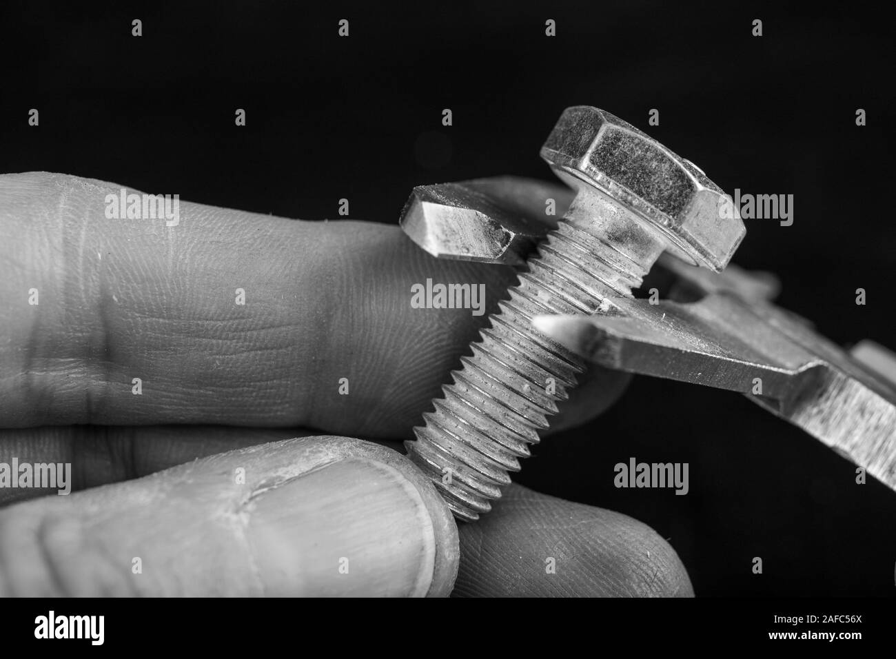 Mesure de compas à l'atelier. Contrôler les dimensions des éléments fabriqués. Fond sombre. Banque D'Images