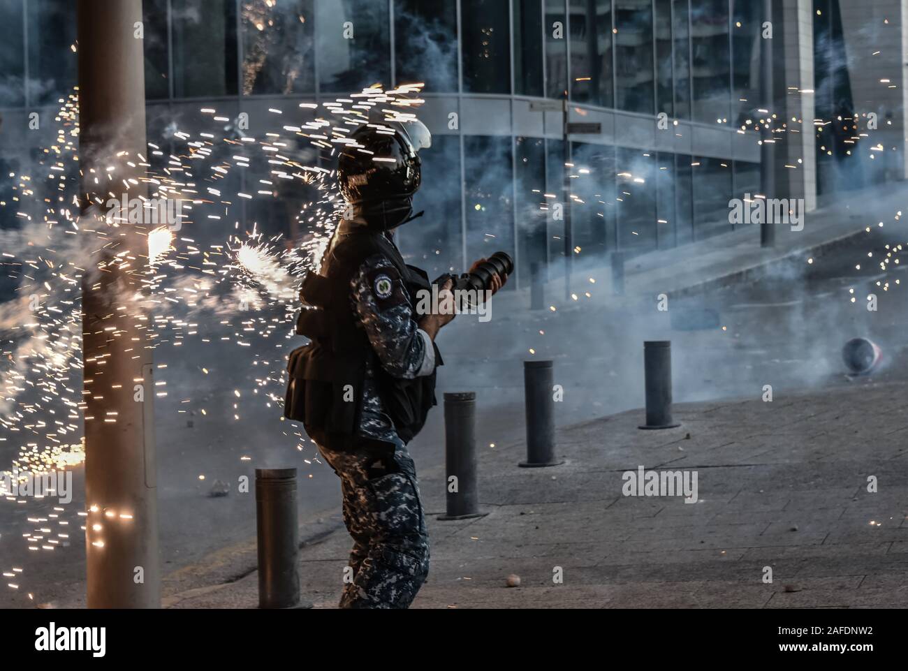 Beyrouth, Liban. 14 Décembre, 2019. Le personnel des forces de sécurité ont attaqué avec Fireworks comme il tire des gaz lacrymogènes sur les gens qui protestent contre une révolte contre le gouvernement libanais sur la 59e journée de protestation. Du quartier chiite de Bachoura, près du centre-ville de Beyrouth, des contre-manifestants ont attaqué la police et le personnel de l'armée avec des pierres et des feux d'artifice le samedi soir. La police a répondu par des gaz lacrymogènes lors d'une bataille de plusieurs heures. Credit : Elizabeth Fitt/Alamy Live News Banque D'Images