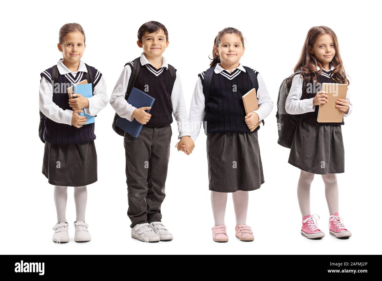 Portrait de trois écolières et écoliers portant un uniforme scolaire isolé sur fond blanc Banque D'Images