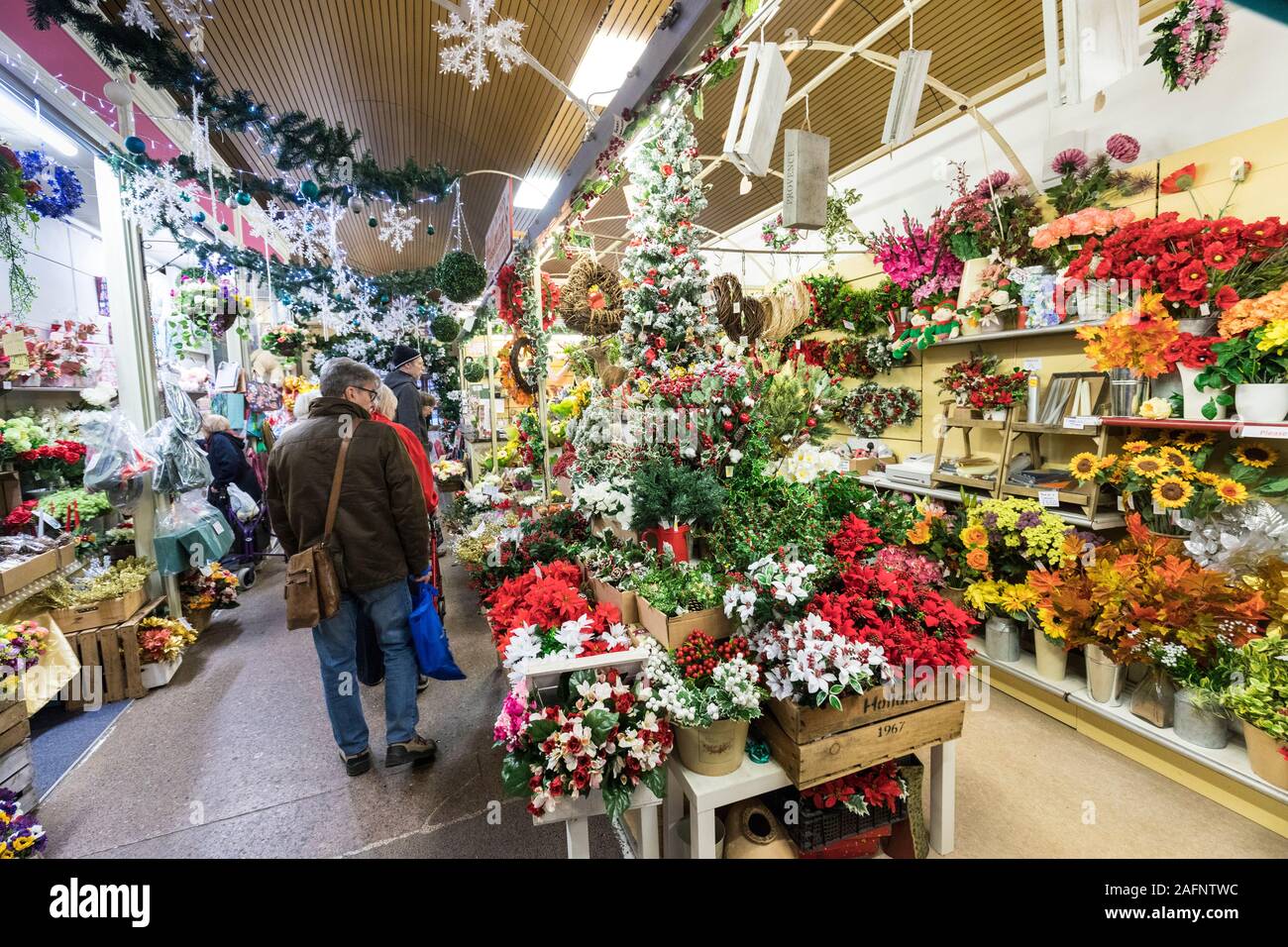 Achats de Noël pour les plantes et les fleurs dans le marché couvert, Hereford, Angleterre, RU Banque D'Images
