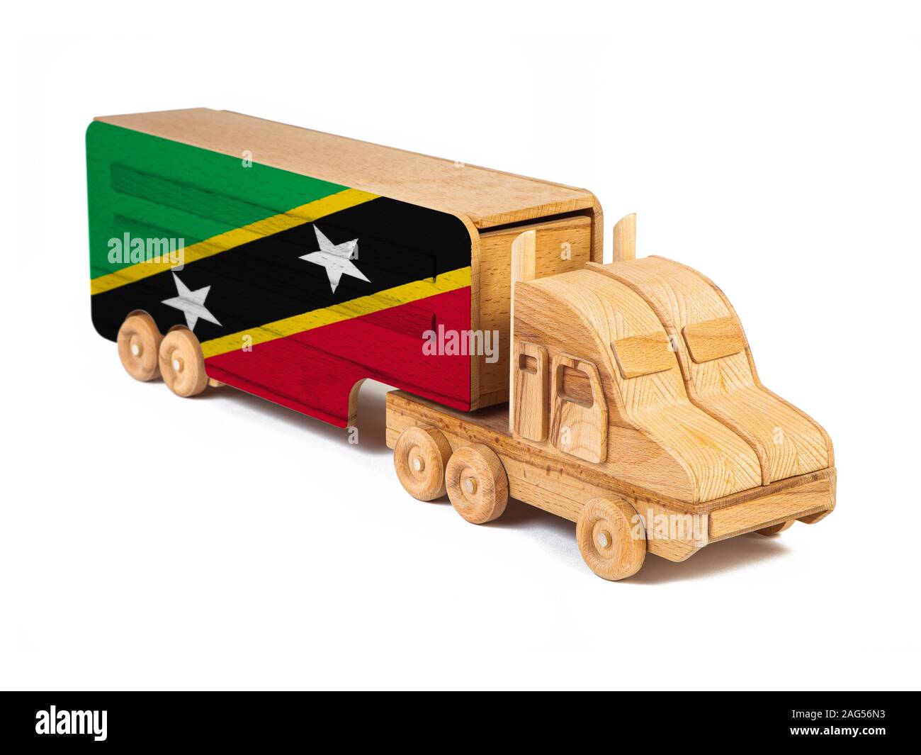 Close-up d'un camion jouet en bois peint avec un drapeau national Saint Kitts et Nevis. Le concept d'exportation-importation, transport, livraison nationale de g Banque D'Images
