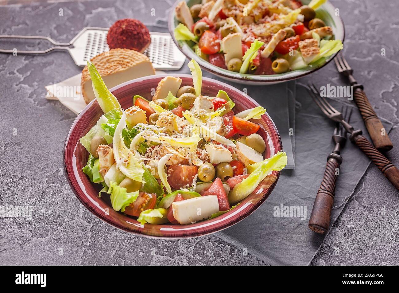 Close-up deux portions de salade végétarienne appétissant avec du pamplemousse, avocat, laitue, d'olives et de fromage fumé. Banque D'Images