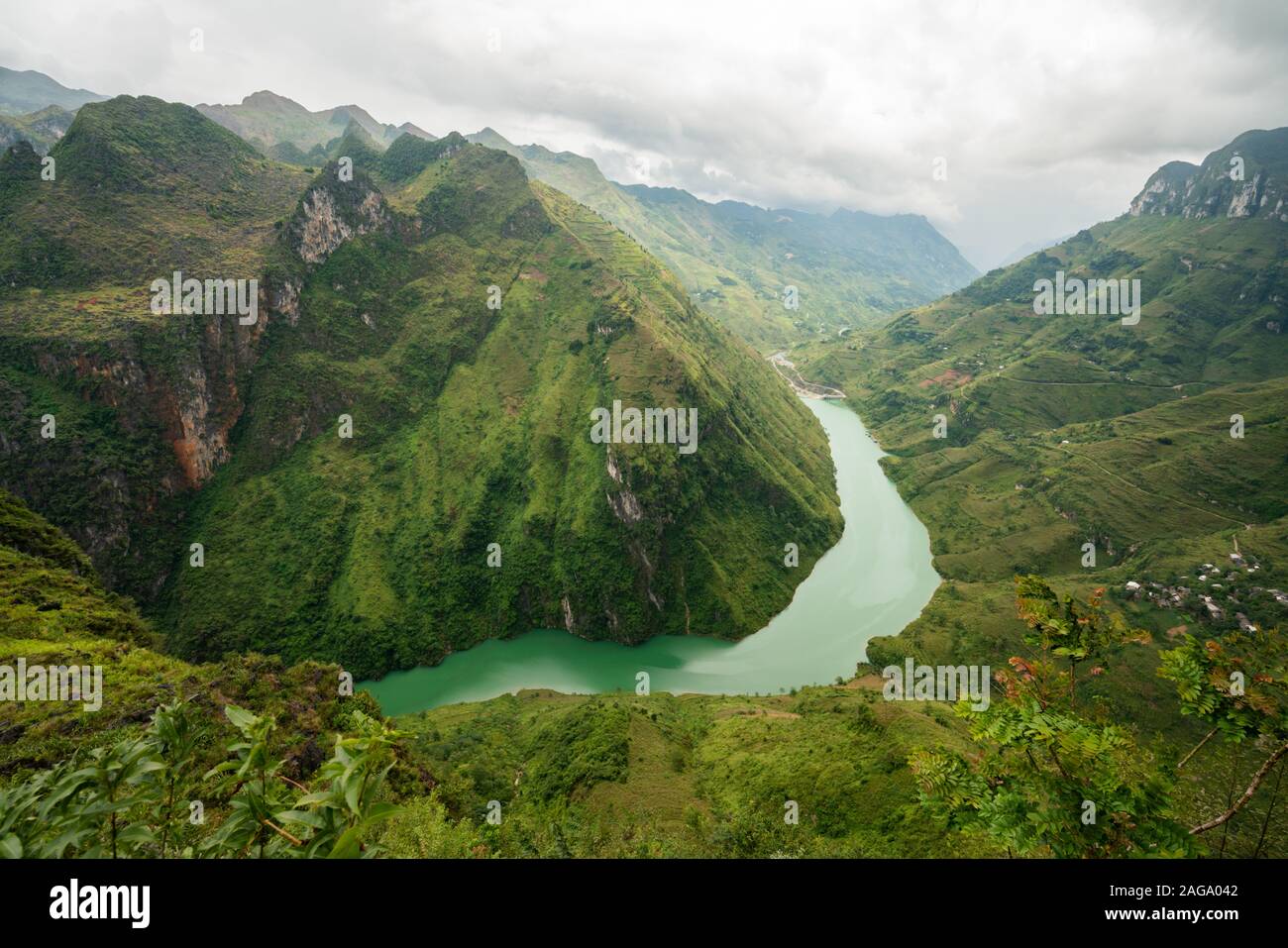 Photo aérienne d'une rivière étroite dans les montagnes sous Le ciel nuageux au Vietnam Banque D'Images