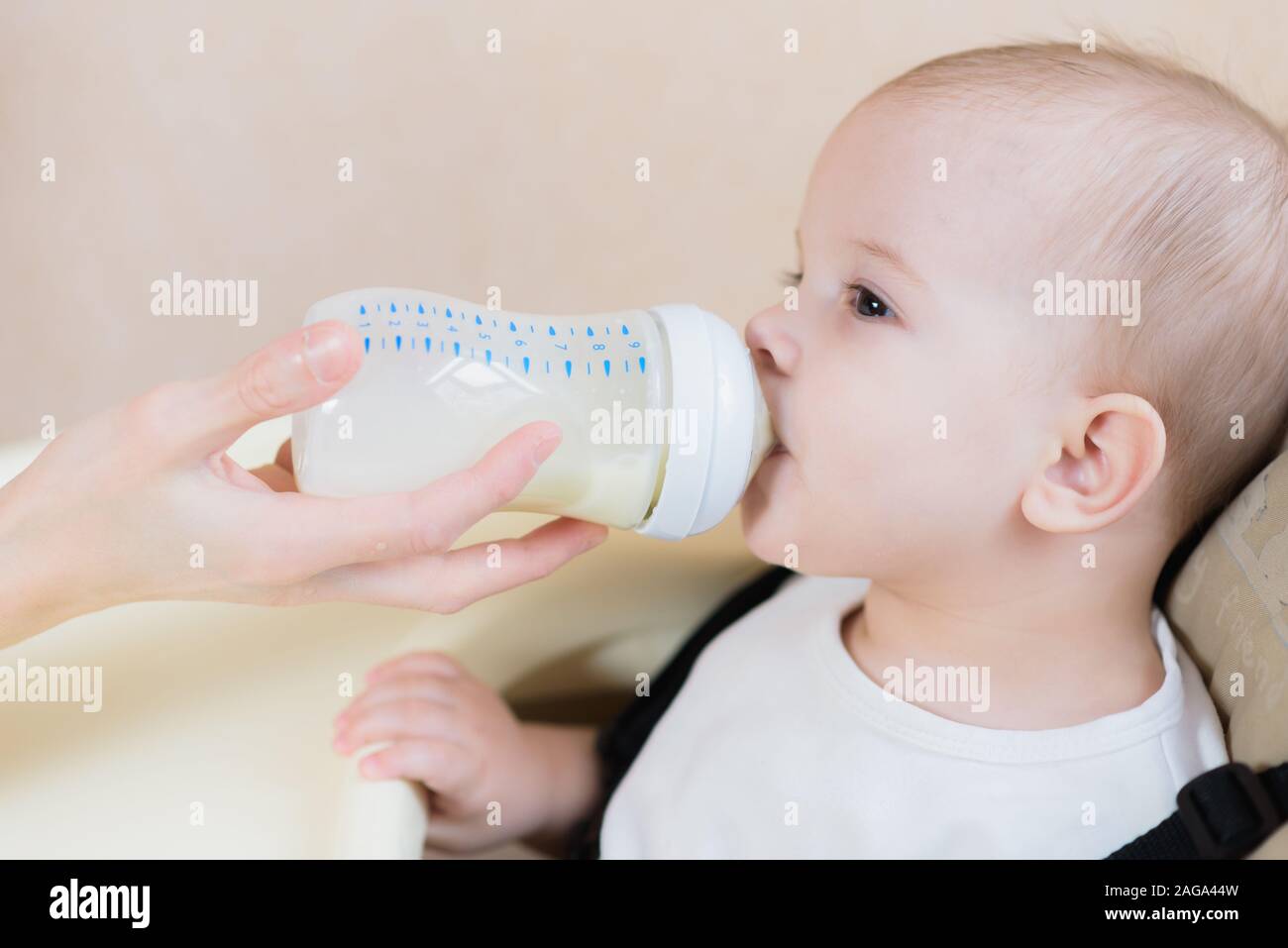 Enfant assis à la table et boire du lait Banque D'Images