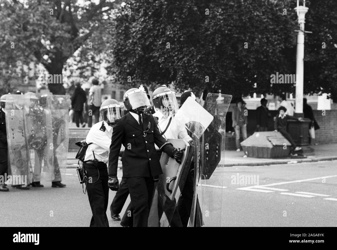 Un policier noir (deuxième à gauche) avec des collègues casqué porter boucliers antiémeutes près de Lambeth de ville à Brixton, Londres, après qu'ils ont essayé de réprimer les émeutes dans la région. Banque D'Images