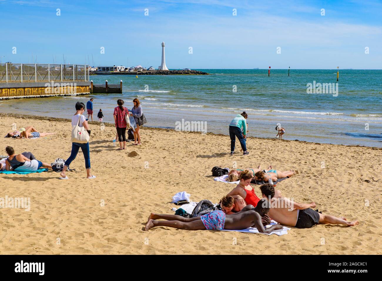 Les personnes bénéficiant de soleil à la plage St Kilda, la plage la plus célèbre de Melbourne, Australie Banque D'Images