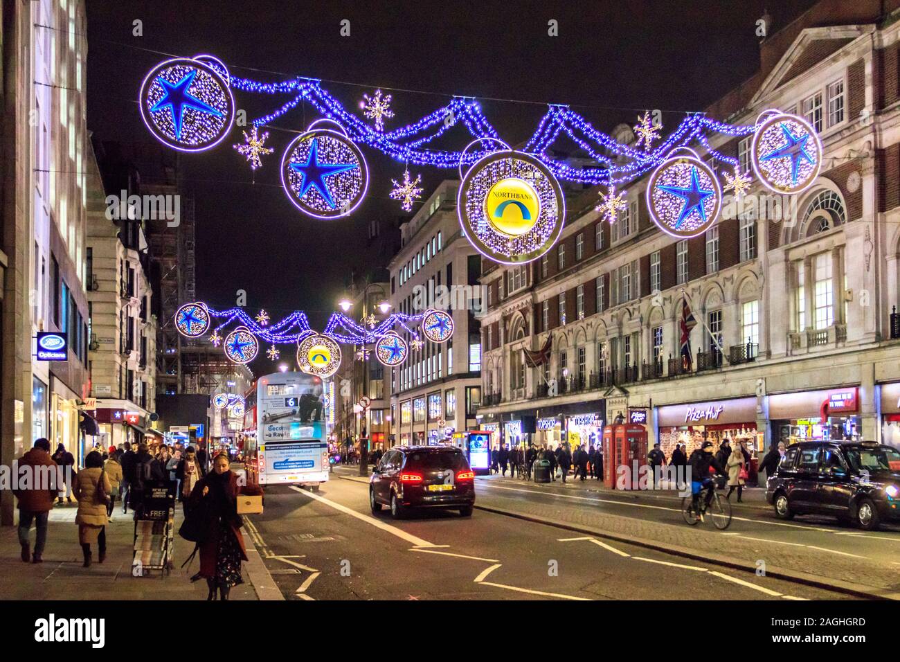 Les consommateurs et usagers dans le Strand, éclairé par les lumières de Noël, Londres, UK Banque D'Images