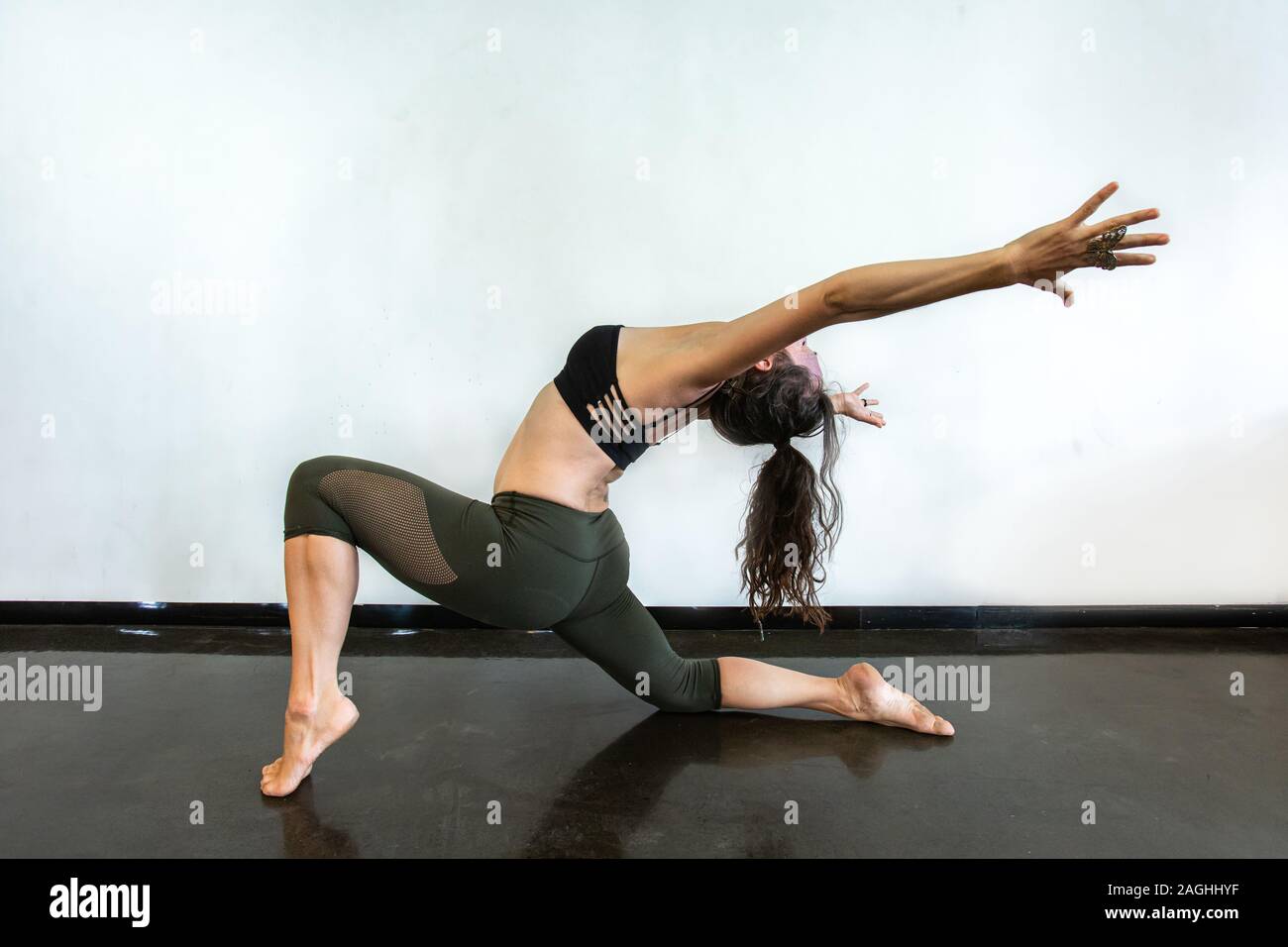 Un portrait tiré d'un gymnaste souple de l'exécution d'une session intensive de yoga Vinyasa Flow, avec des lignes de corps comme elle s'étire vers l'arrière Banque D'Images