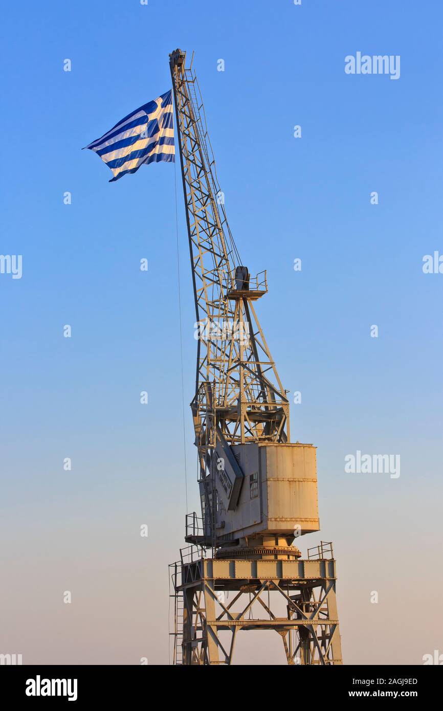 Le drapeau grec battant fièrement sur le haut d'une grue du port de Thessalonique, Grèce (Macédoine) Banque D'Images