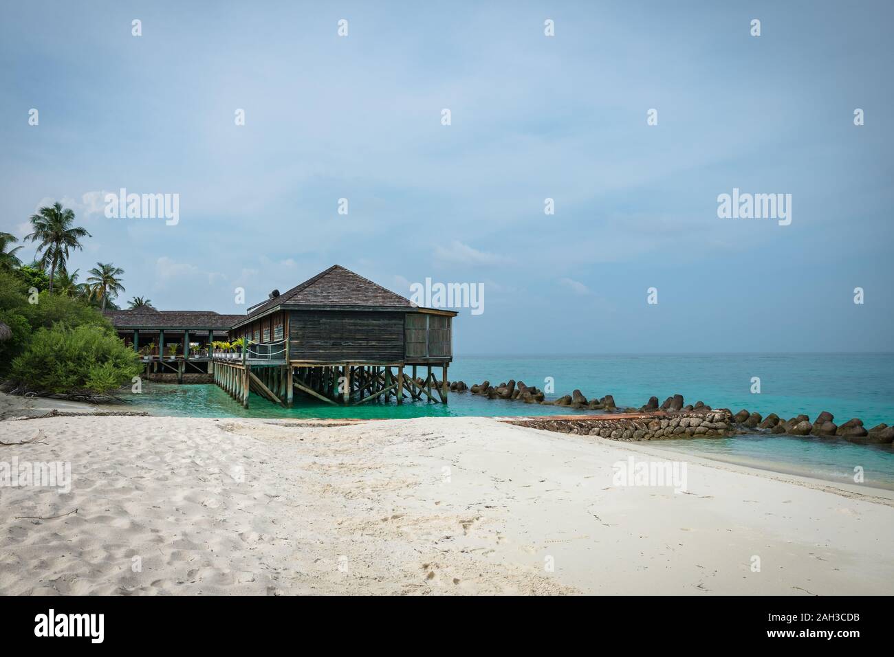 Les bungalows et les maisons dans les Maldives avec belle mer turquoise et nuages dans le ciel Banque D'Images