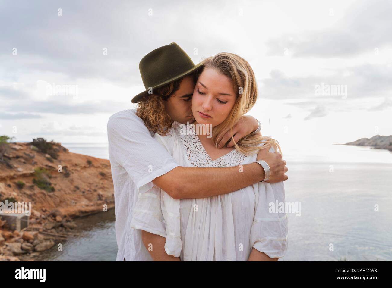 Jeune couple dans l'amour debout en face de la mer, Ibiza, Baléares, Espagne Banque D'Images