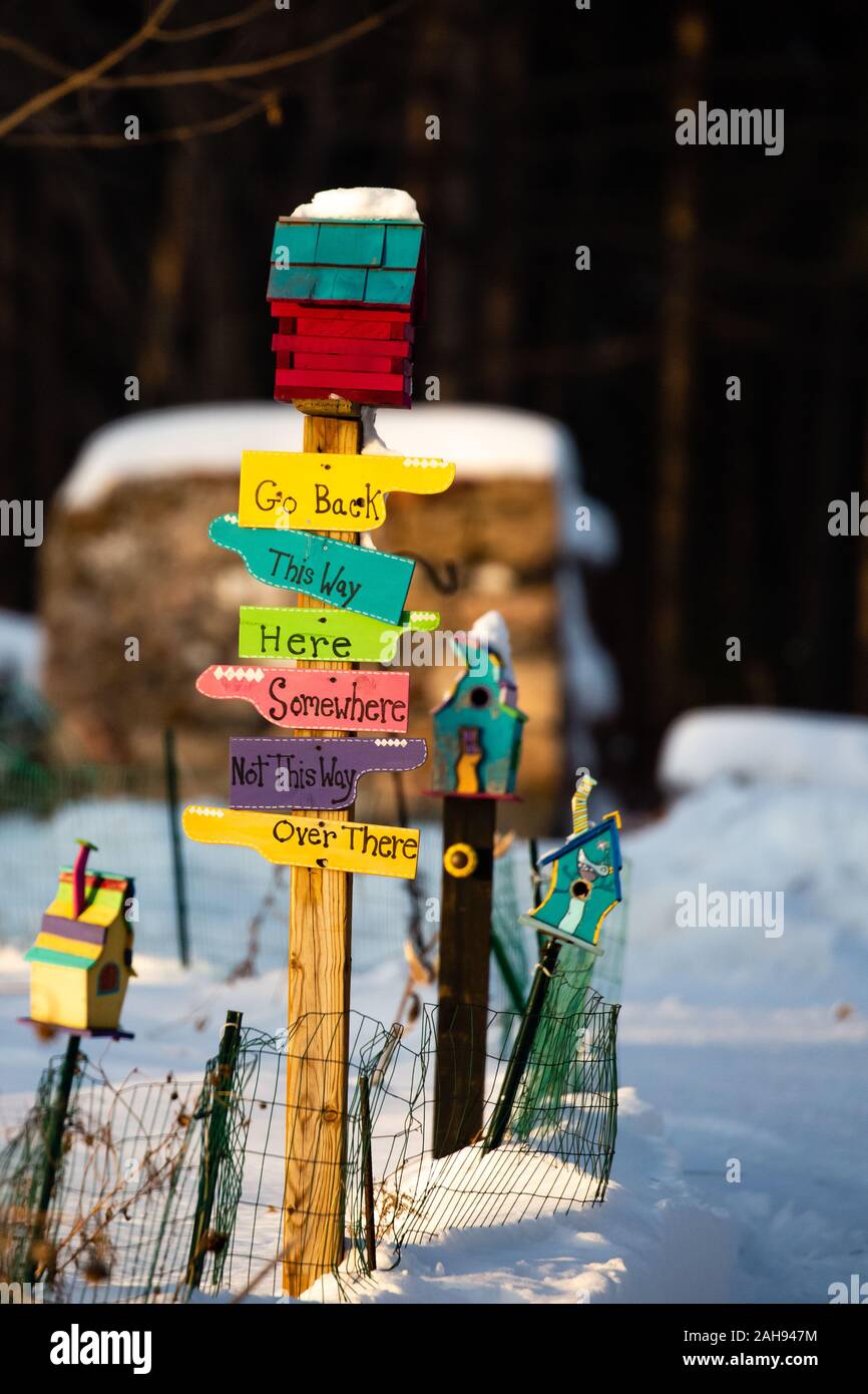 Maisons d'oiseaux colorés et signe avec la neige sur le sol en hiver Banque D'Images