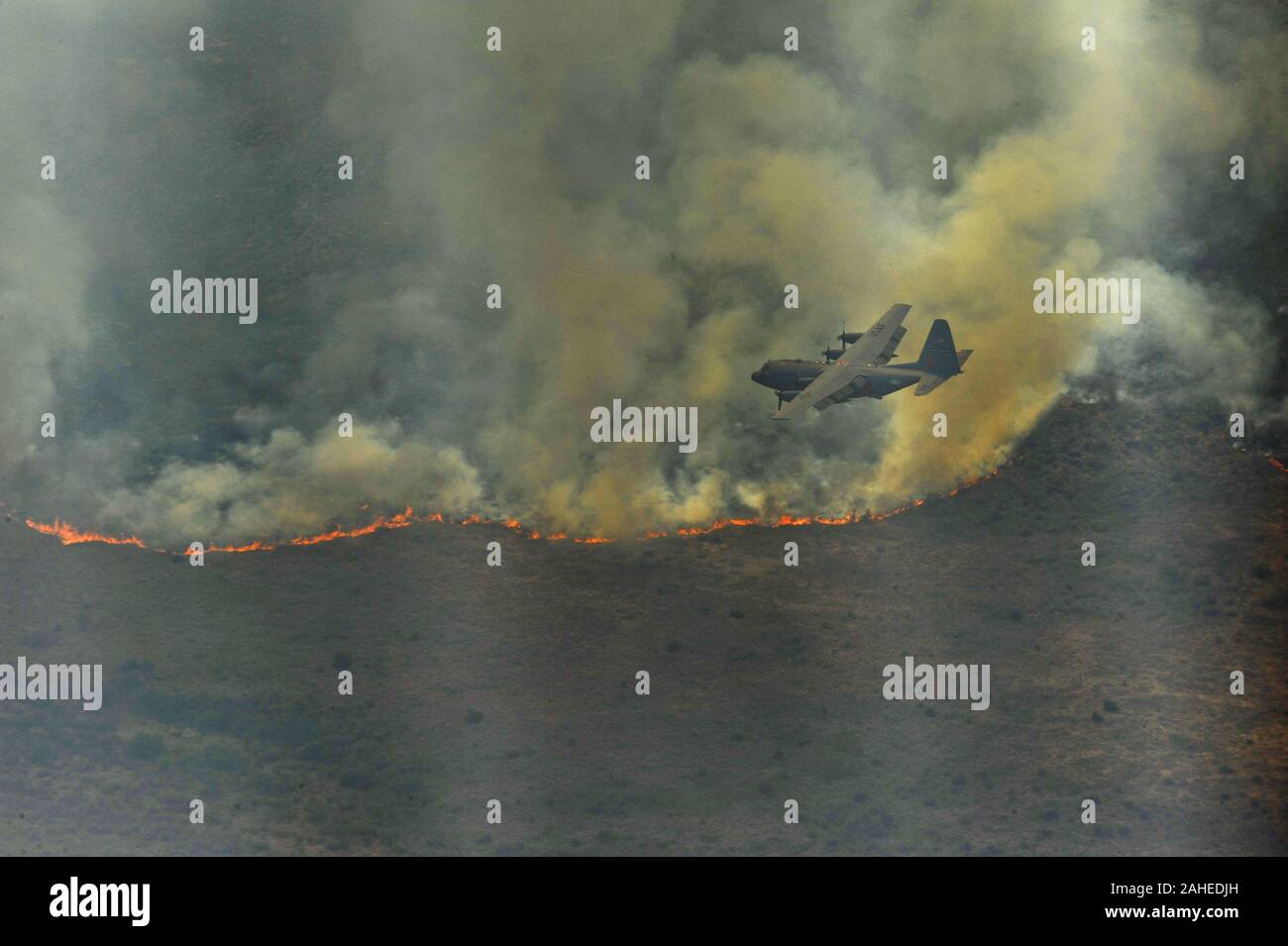 Un C-130H Hercules du 302e Airlift Wing, Colorado Springs Air Force Reserve, équipé de la lutte contre les incendies en vol modulaire système se prépare à abandonner une ligne de feu dans l'ouest du Texas, le 27 avril. MAFFS est capable de distribuer 3 000 gallons d'eau ou de flammes dans moins de 5 secondes. Les friches ont réparties dans diverses parties du Texas et ont brûlé plus de 1 000 milles carrés de terres. Banque D'Images