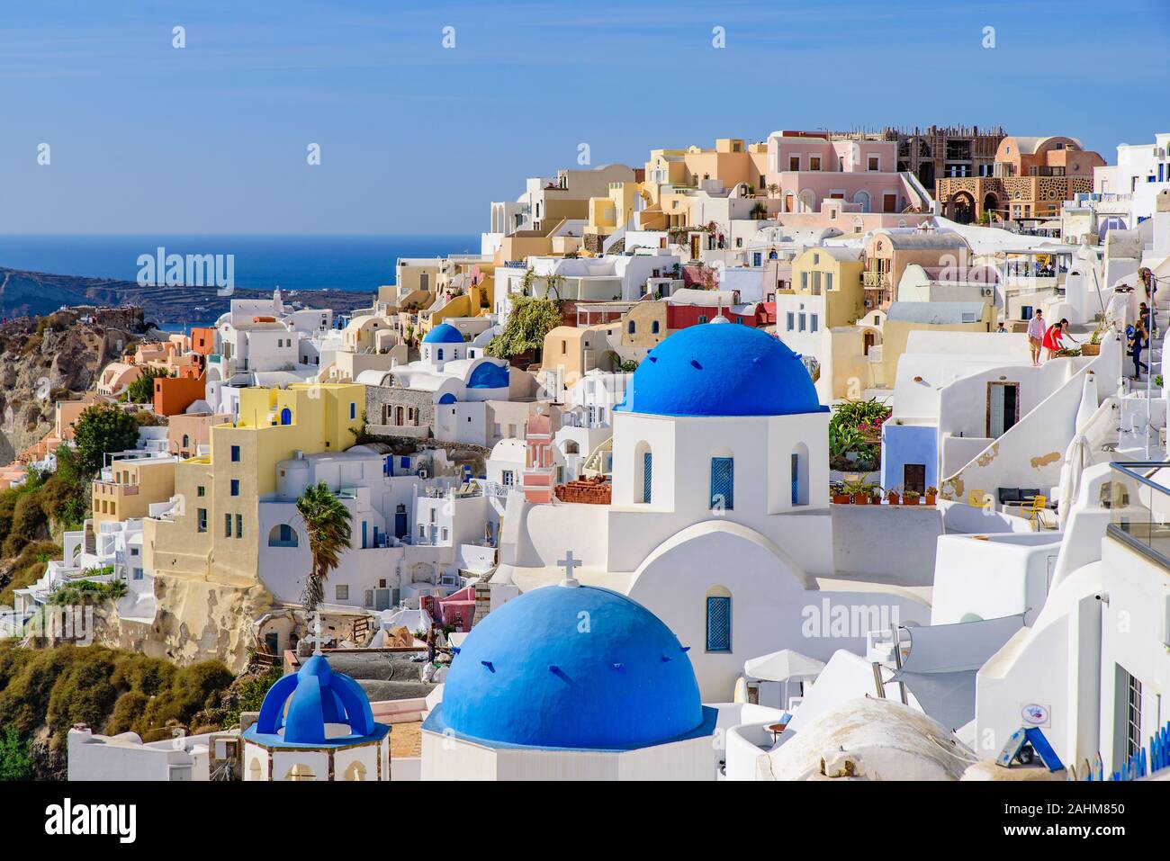 L'église au dôme bleu et blanc traditionnel face à la mer Egée maisons à Oia, Santorin, Grèce Banque D'Images