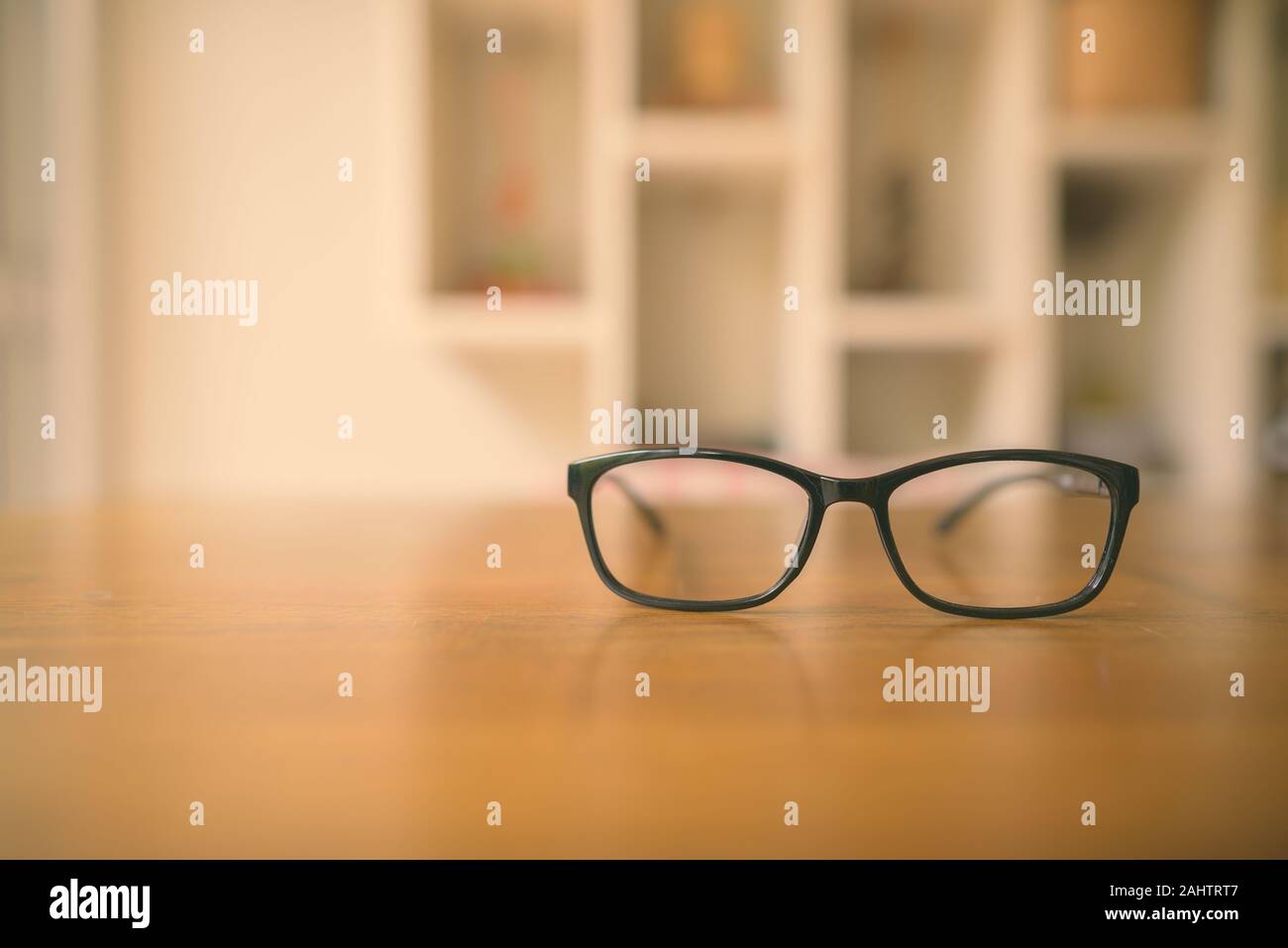 Les lunettes qui met sur la table en bois à coup horizontal Banque D'Images